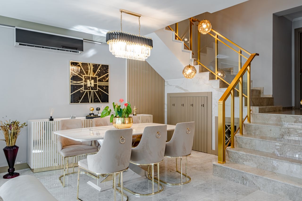 get-in-touch Modern dining room with marble table, gold accents, and stylish lighting.